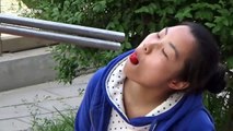 Chinese man uses giant chopsticks to feed fruit to woman
