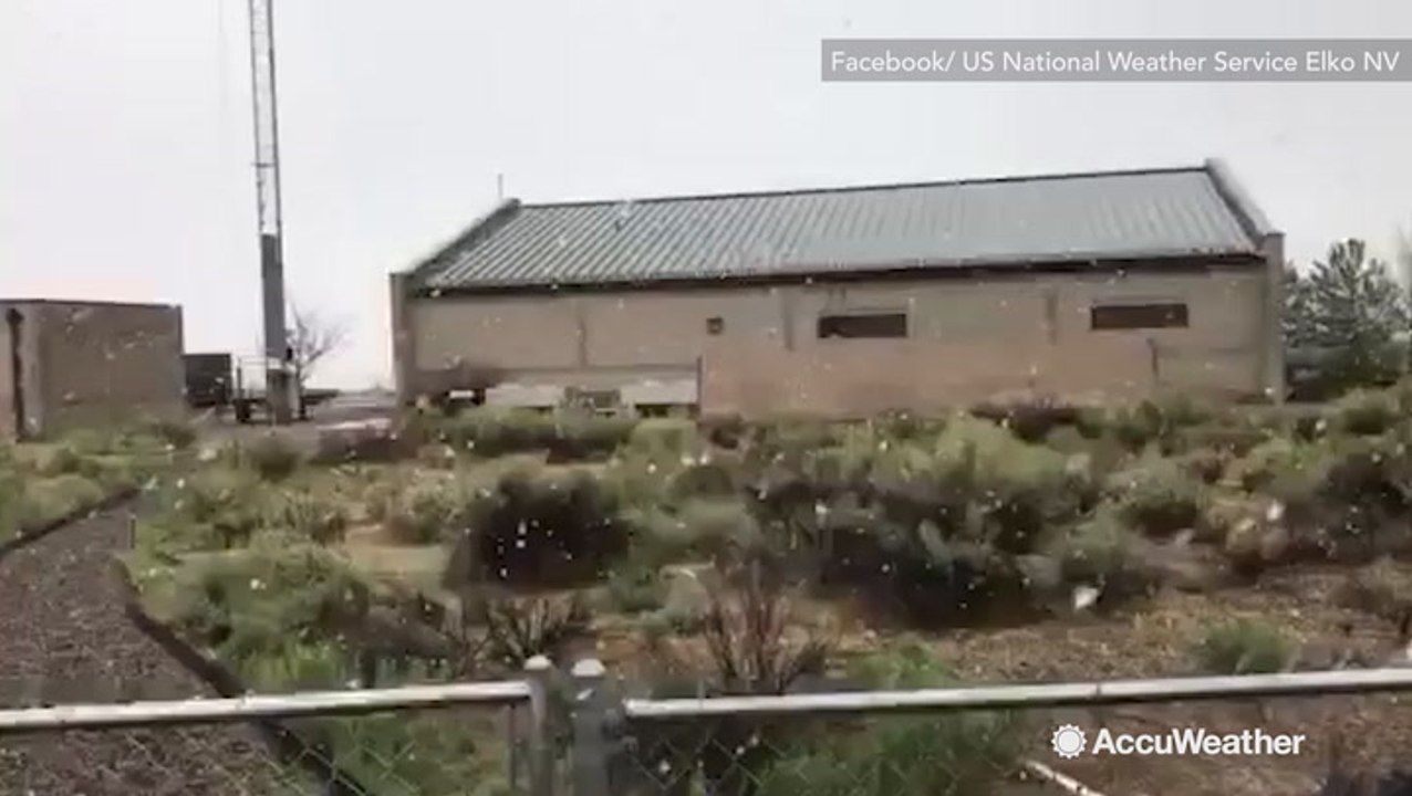 Light snow falls on desert town