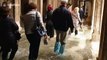 Tourists forced to wade as unusually high tide floods Venice