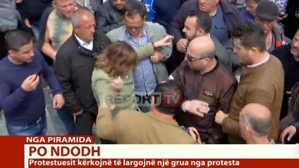 Descargar video: Report TV - Protesta e opozitës/ Përplasen fizikisht një burrë dhe një grua