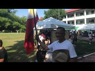 Man brings Philippine flag to polling precinct, votes for opposition senators