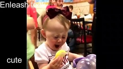 baby tries lemon for the first time