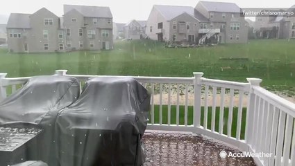 Hail falls in slow motion, bouncing off porch