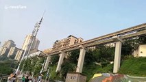Elevated trainline runs through hole in building in China's Chongqing
