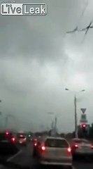 Building rooftop blows into the road