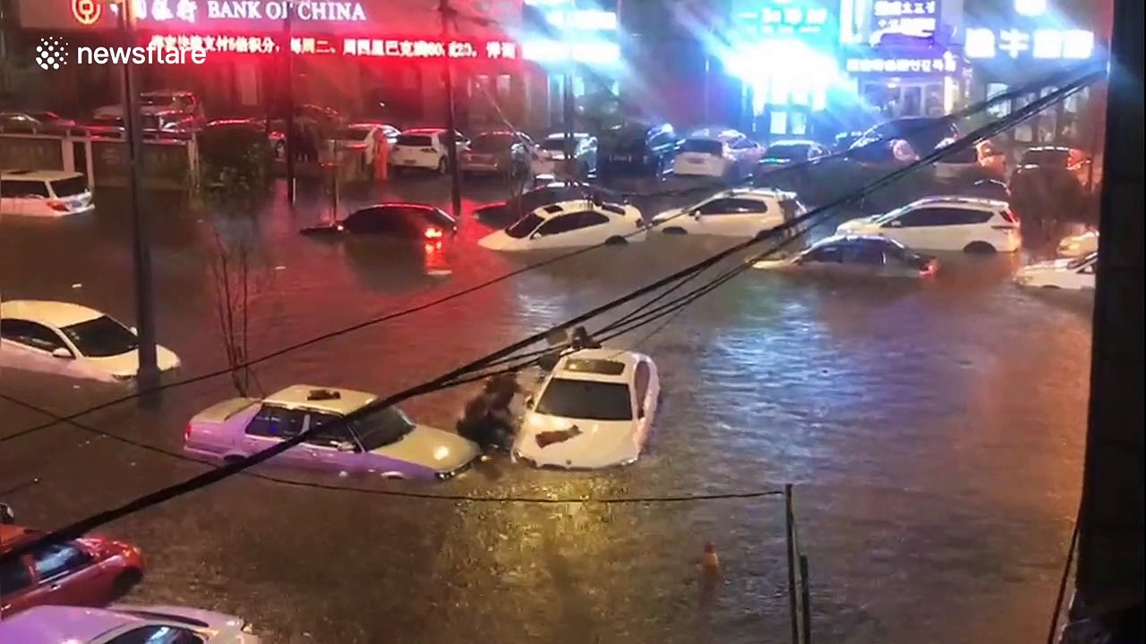 Vehicles submerged in deep water after heavy rainstorm causes floods in China