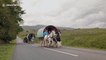 Travellers drive their horse-drawn caravans up steep hill on their way to Appleby Horse Fair