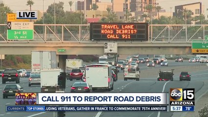 Call 911 to report road debris