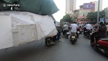 Ridiculously overloaded motorcycle cart carries 6m stack of foam boxes