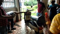 Snake-catcher pulls deadly king cobra from motor scooter
