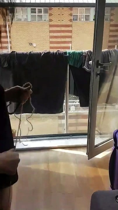 Elle récupère sa culotte sur le balcon du voisins d'en-dessous avec une corde !
