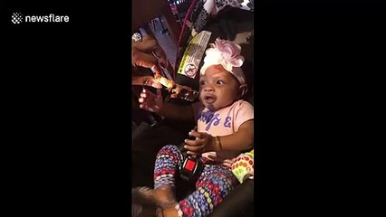 Cute hungry baby excited to try her first rib