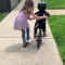Adorable Girl Coaches Little Brother to Ride Two-Wheeled Bike