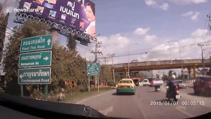 Concrete pipe falls off truck nearly crushing drivers on busy road in Thailand