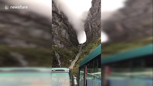 Mysterious scene shows clouds flowing through a mountain passage in China's Hunan