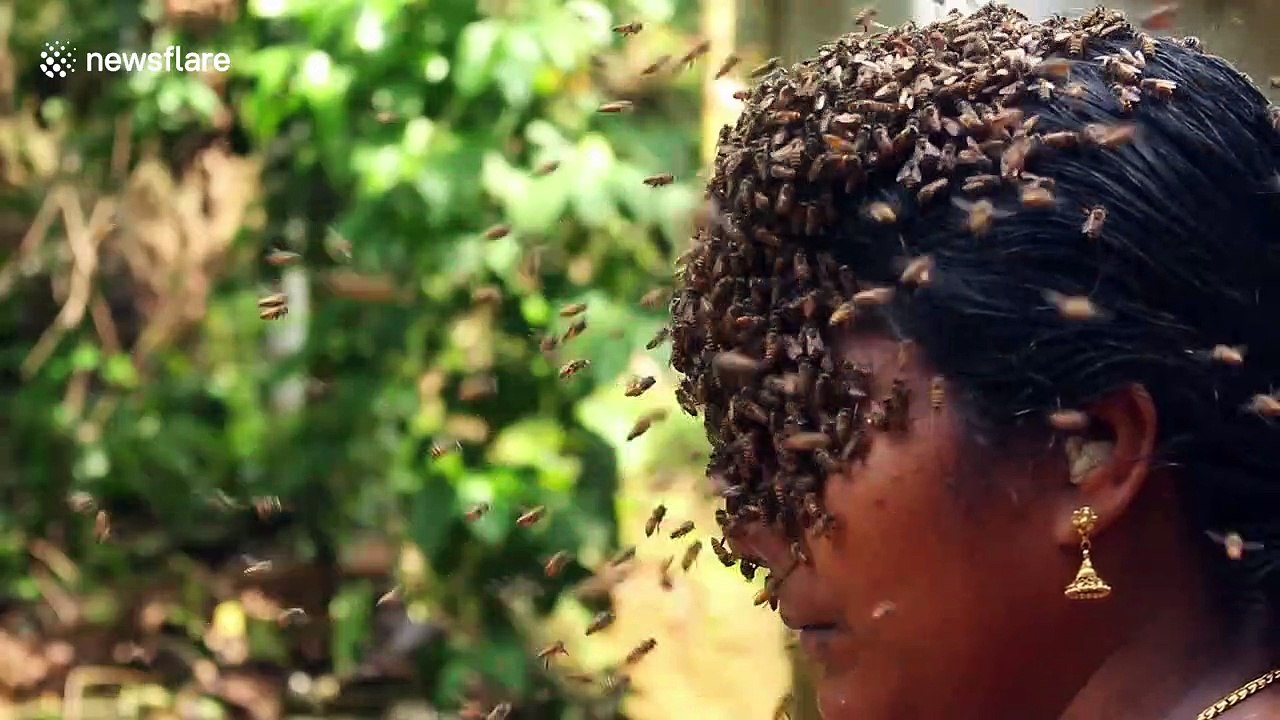 Indian woman covers face with hundreds of bees to create buzz for conservation