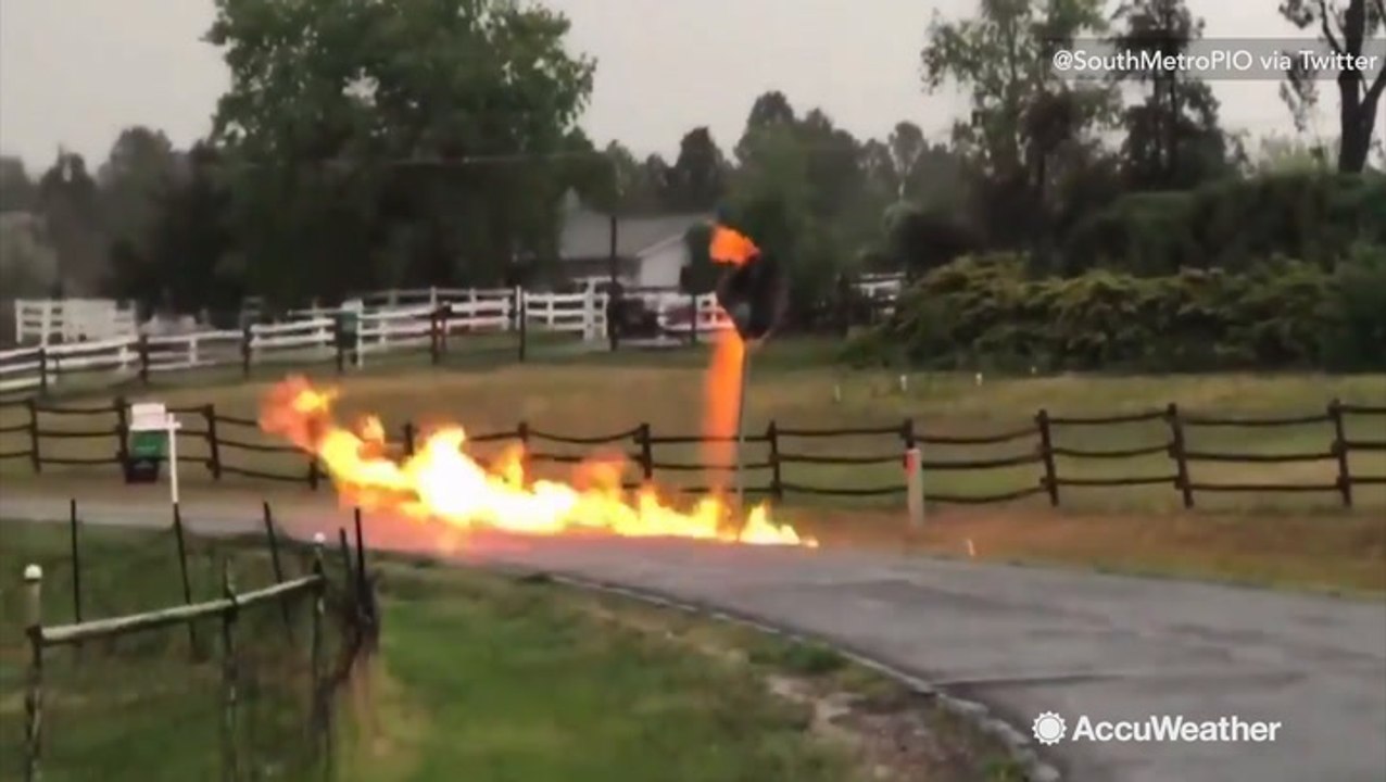 Street sign ignites into raging fire after ligh...