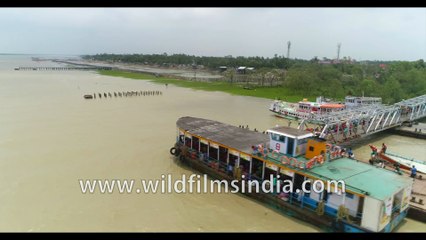 Kakdwip to Gangasagar local ferry, River Hooghly meeting the Bay Of Bengal, West Bengal, India. 4k Aerial stock Footage.