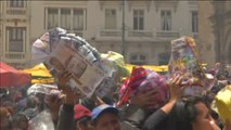 Miles de devotos en Bolivia piden al dios de la abundancia que les conceda los pequeños artículos pero en tamaño real