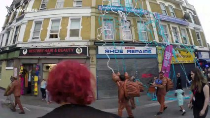 Whacky performers blast UK high street with streamers and confetti