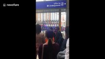 Commuters wait outside evacuated Victoria station after fire alert