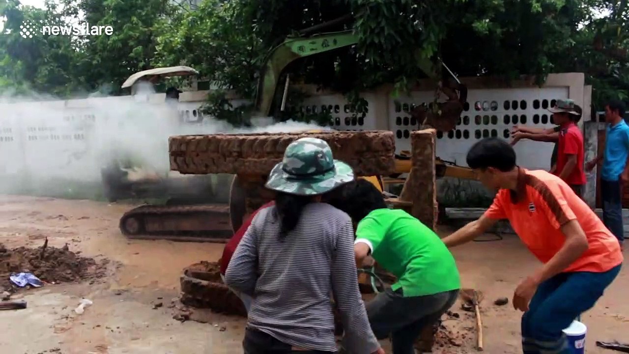 Dramatic moment builder is rescued from overturned backhoe that burst into flames