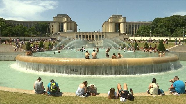 A pool with a view: tourists take dip in fountain in front of Eiffel Tower
