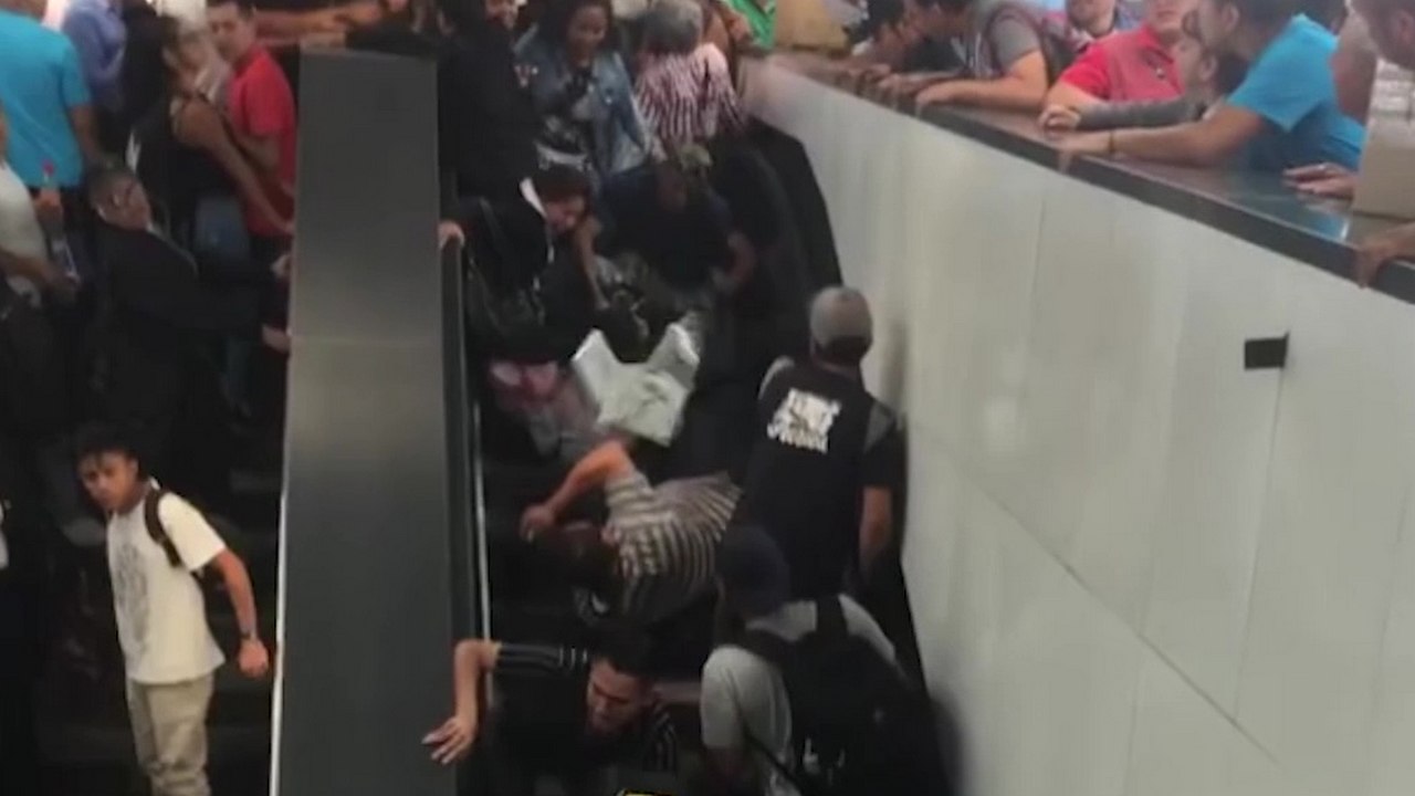 Des personnes prennent l'escalator alors qu'il n'y a plus de place à la sortie