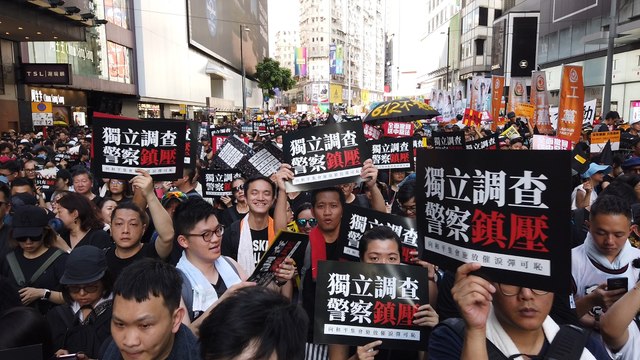 Sea of protesters march through downtown Hong Kong on July 1 handover anniversary