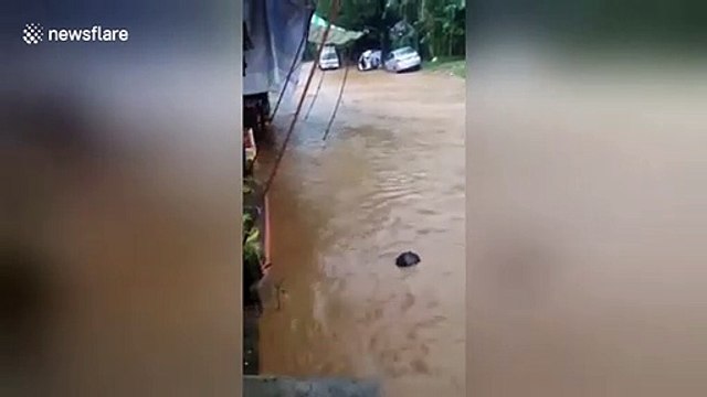 Students stranded inside classrooms as flash flooding hits the Philippines