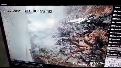 Heavy rains cause wall to collapse onto cars