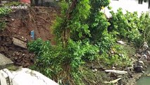 Monsoon landslides leave homes hanging dangerously over river in the Philippines