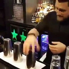 Un barman impressionne des clients en faisant un tour de magie avec des fruits