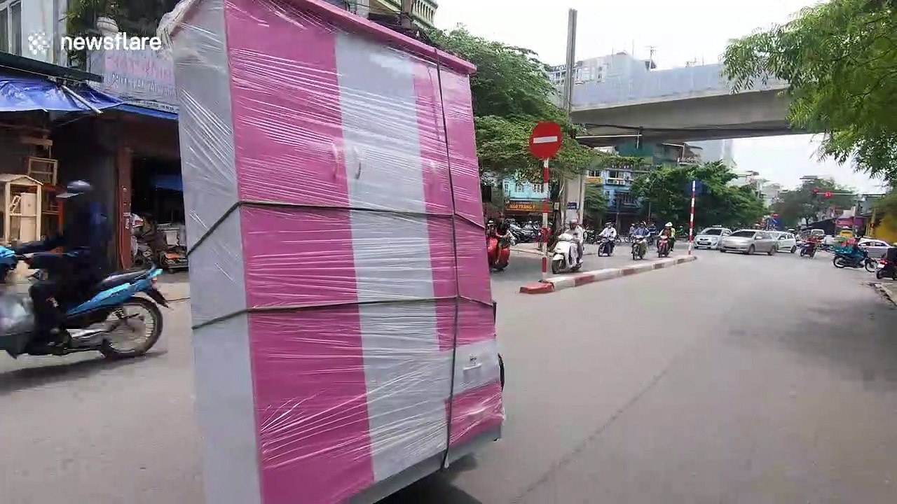 Flying wardrobe? Motorcyclist drives with huge cabinet on busy road in Vietnam