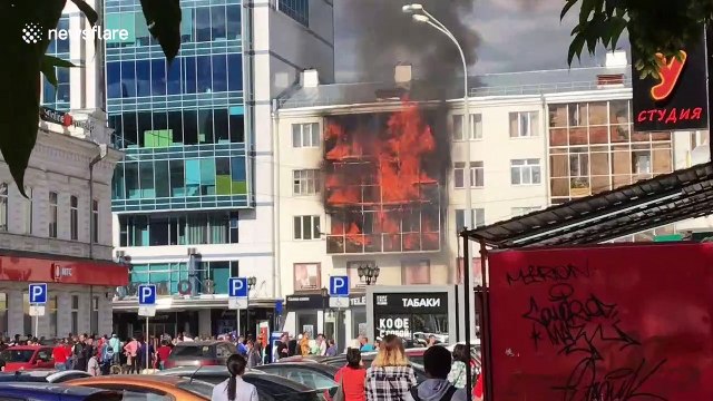 Crowd watches as flames engulf apartment block in Russian city