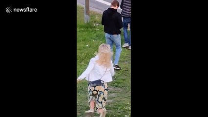 A Woman attempts a cartwheel gone wrong