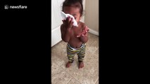 Cute baby imitates someone blowing their nose