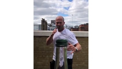 Jason Statham removes a bottle cap