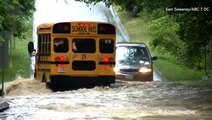 School bus drives through dangerously high floodwaters