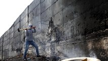 Palestinian artist: Israel's separation wall scary racist symbol