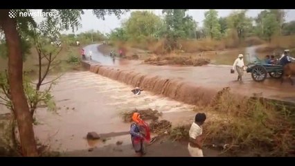 Intense moment as motorcyclist gets swept away by flooded road in India