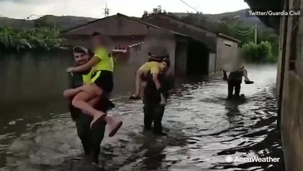 Rescuers wade through floodwaters in Spain