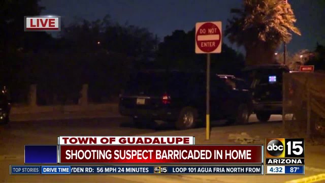 Shooting suspect barricaded in home