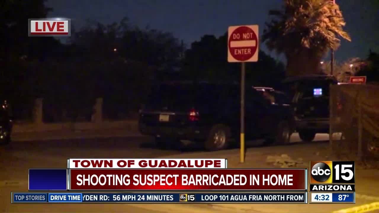 Shooting suspect barricaded in home