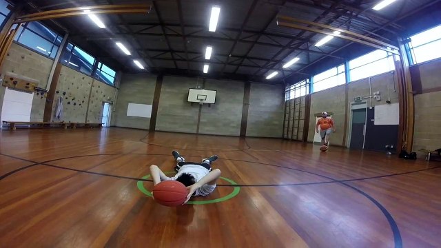 Allongé il marque un panier de basket du milieu de terrain !