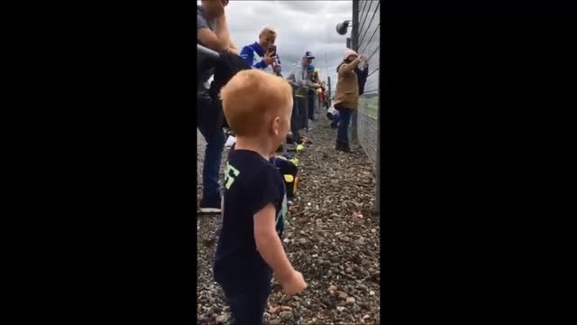 Logan Cox reacts to motorbikes at the Moto GP at Silverstone