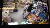 Armed robber points gun at terrified shop assistant