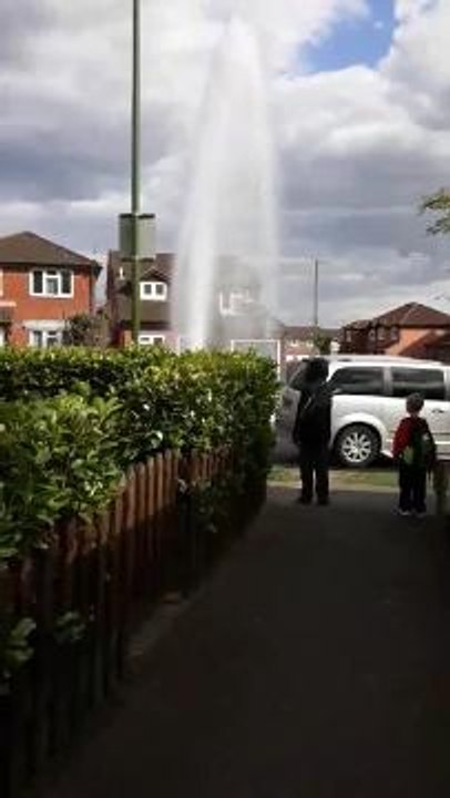 Water explodes from pavement