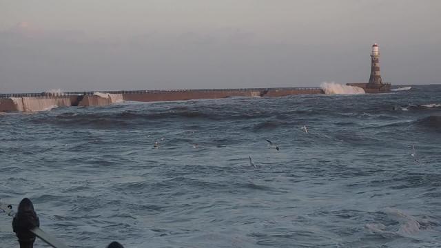 Waves crash against Roker Pier