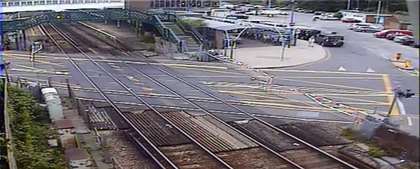 Motorist smashes into level crossing barriers